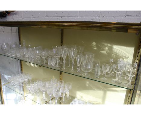 A shelf of cut glass and other drinking glasses.