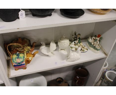 A shelf of decorative china.