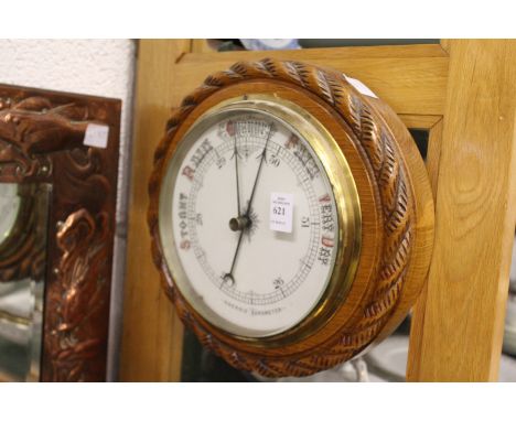 A Victorian oak framed aneroid barometer.