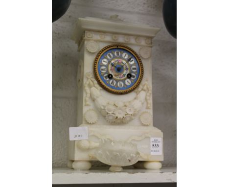 A carved alabaster mantle clock with Sevres style porcelain dial (some losses).