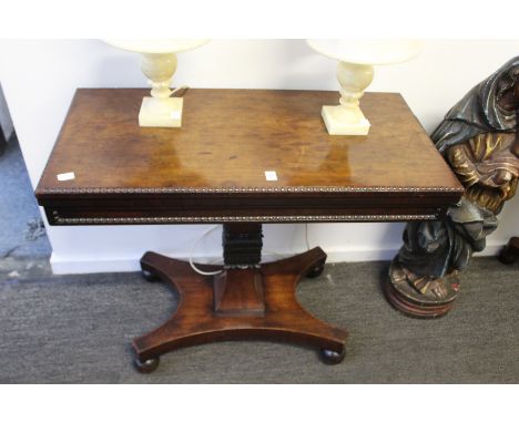 A good 19th century mahogany rectangular foldover card table on a carved column support with platform base.