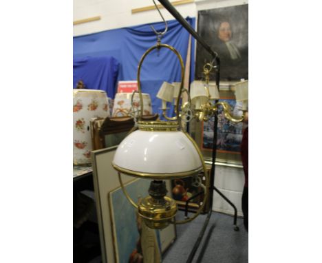 A ship's hanging brass and opaque glass oil lamp.