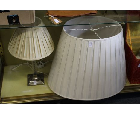 A table lamp and a large lampshade.