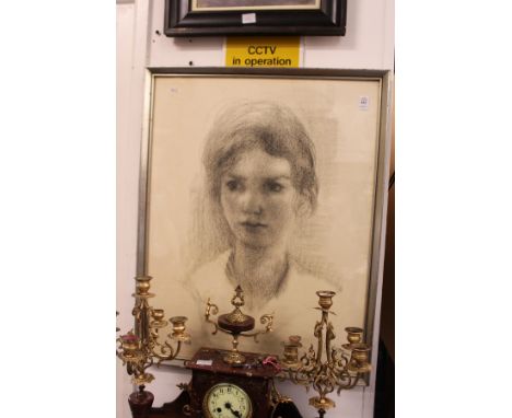 A portrait bust of a young girl, charcoal, signed and dated.
