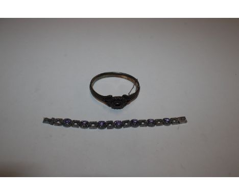 A silver gilt and garnet set snap bangle, 33gms; and a white metal and marcasite amethyst coloured stone set bracelet, 30gms 
