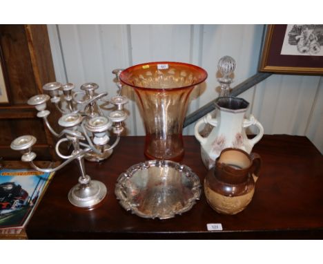 A orange tinted glass vase, a decanter and stopper, a pair of candelabra, a Doulton Lambeth Harvest ware jug, and a West Germ