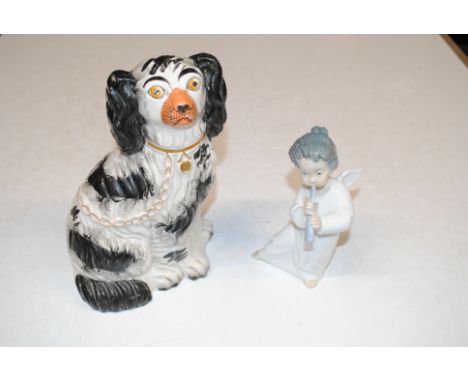 A Staffordshire spaniel and a Lladro figure in the form of an angel