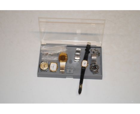 A box containing Timex wrist watch and various other wrist watches
