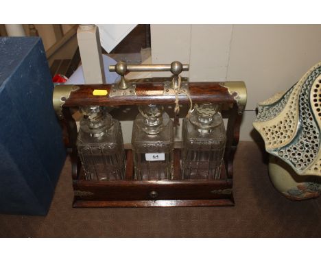 An oak and plate mounted three bottle Tantalus