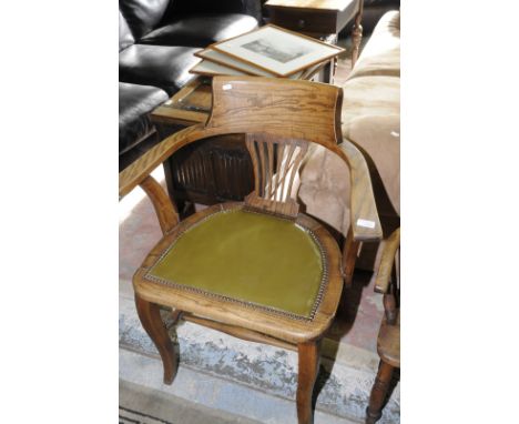 Edwardian light oak office style wide boy armchair with leather upholstered seat and double H shaped under stretcher 