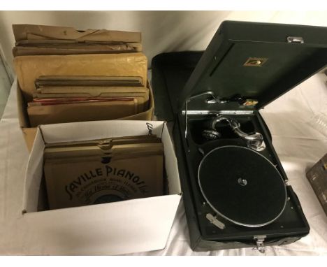A vintage travel gramophone; together with 78s