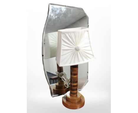 A turned specimen wood table lamp, and an Art Deco un-framed mirror 