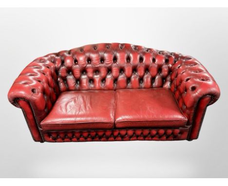 A Chesterfield red button leather three-seater settee, width 193 cm 