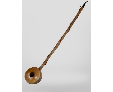 A large rustic smoking pipe, length 70cm.
