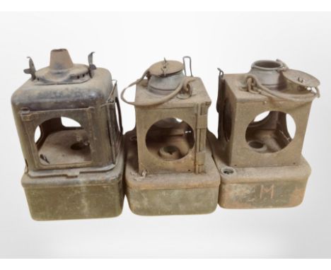 Three antique metal lanterns, a set of enameled scales with weights.