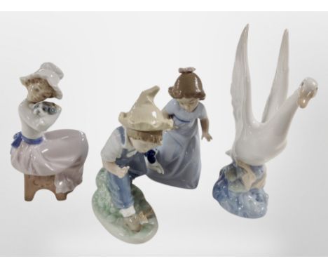 Three Nao figures of girls and a boy, and a futher swan figure.