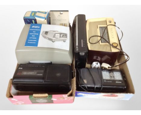 A box containing vintage and later radios, Aldis projector, etc.