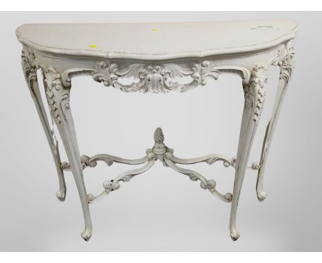 A French carved and cream painted serpentine front console table, width 102 cm 