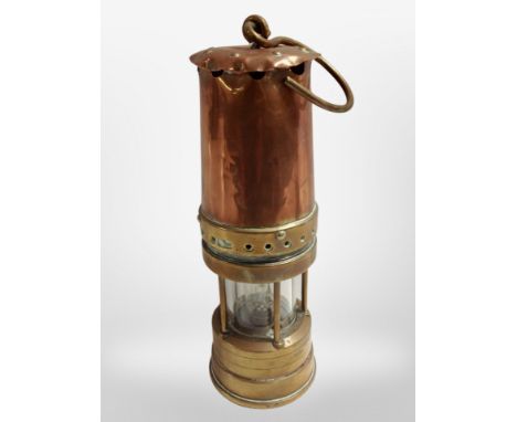 A copper and brass Protector miner's lamp.