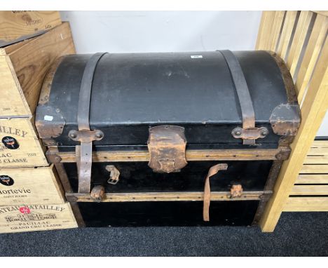 An early-20th century canvas and leather-bound domed trunk, width 78cm.