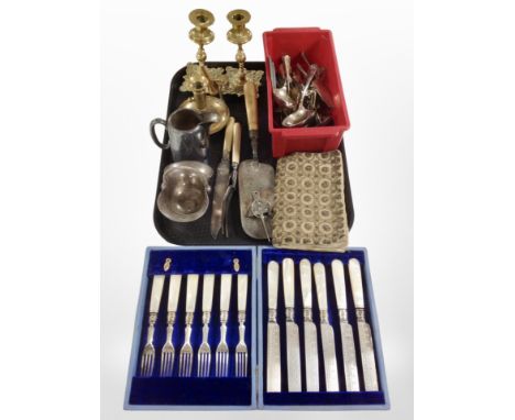 A pair of cast brass candlesticks, a chamber stick, several pieces of silver plate, cutlery, etc.