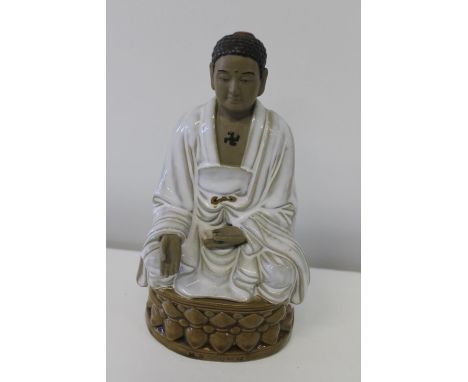 A ceramic Chinese Budhist figure 