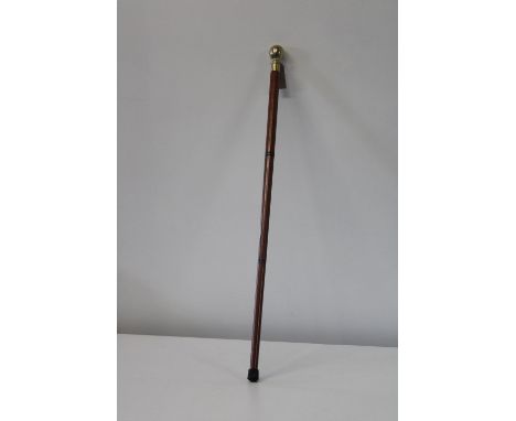 A brass topped walking stick with hidden glass flask 