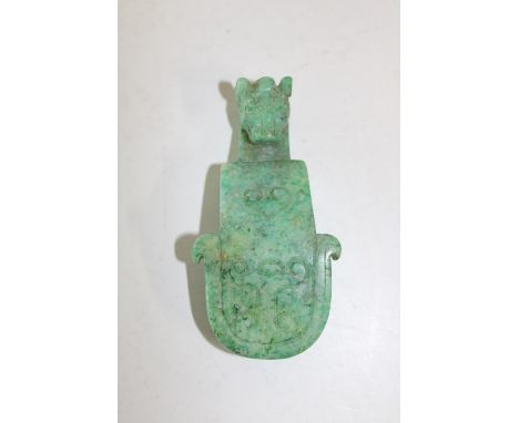 A Chinese green jade belt hook in the form of a dragon 