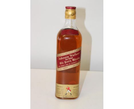 A vintage bottle of Johnnie Walker red label old scotch whiskey 26 2/3 fl ozs 70% proof 