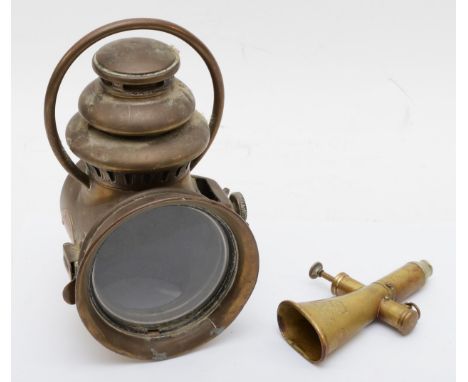 A Kohler &amp; Son brass signal horn, 15cm long, together with a brass oil lamp 'Nirona' No 10 (2)