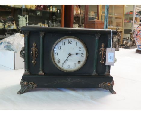A late 19th century ebonised mantel clock, dial signed Sessions, frontage with Corinthian columns, with key and pendulum, 14.