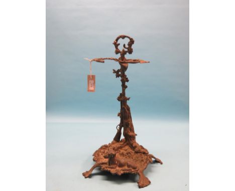 A Victorian brass stick-stand, cast with shotgun and hound, together with a large brass dressing mirror, four-sconce candelab