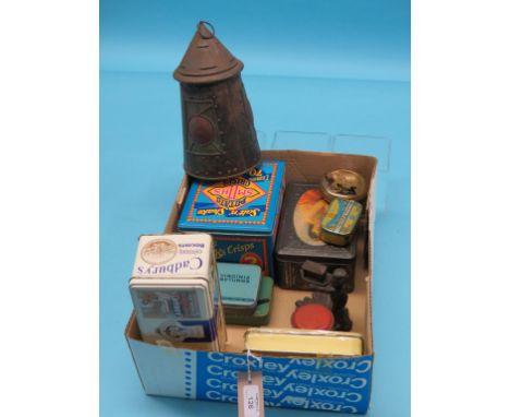 A novelty lantern biscuit tin, pillar-box money bank, seven other various tins, cast iron match-holder, figure holding arc-st