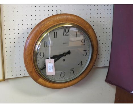 A Victorian dial clock, 9.5in. silvered dial and oak surround, with key 