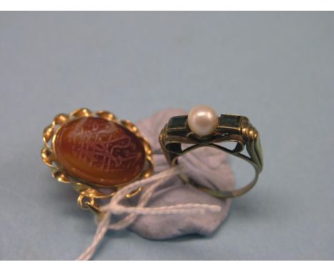 A yellow metal dress ring, two step-cut green stones and central pearl, stamped 333, size N, together with a yellow metal pen