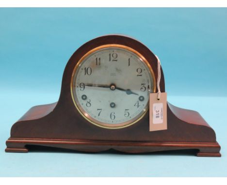 A domed mahogany mantel clock, silvered dial signed Piggott, Worthing, chiming movement with key and pendulum, 16in.