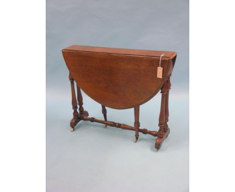 A Victorian oak Sutherland table, on turned underframe with ceramic casters, 2ft. 9in. 