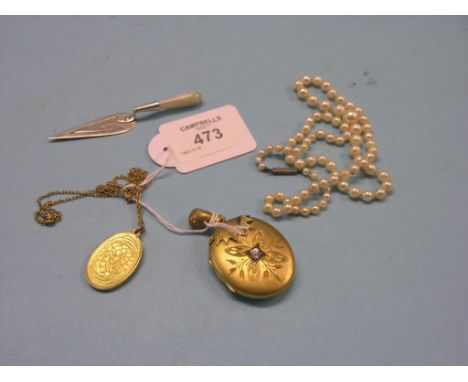 A Victorian gold plated locket pendant, an oval silver-gilt pendant on chain, pearl-type necklace and a silver trowel-shape b