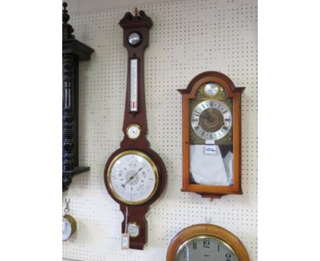 A period-style wheel barometer, 42in., together with a similar wall clock with arched, brass dial