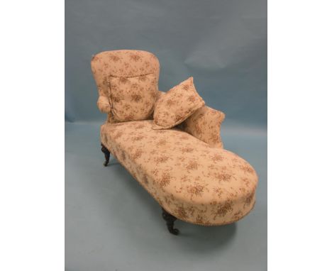 A Victorian chaise longue, upholstered in a machine tapestry, on turned legs with casters