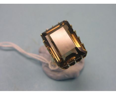 A 14ct. gold dress ring, large, step-cut topaz in claw setting