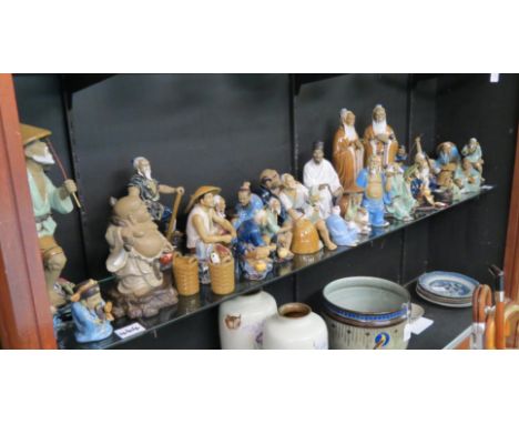 A collection of Chinese ceramic figures, male artisans at various pursuits, tallest 13.5in., 28 total