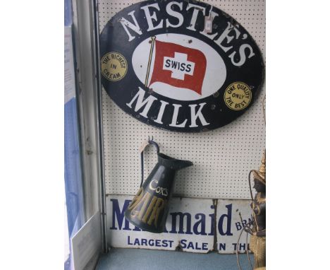 Two enamel signs, Nestle's and Milkmaid Milk, 28 and 44in. resp., as viewed, together with a Cox's Dairy milk jug, 15in.