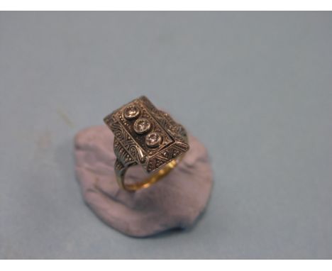 An Art Deco 18ct. gold ring, rectangular intaglio setting with three small diamonds, size K