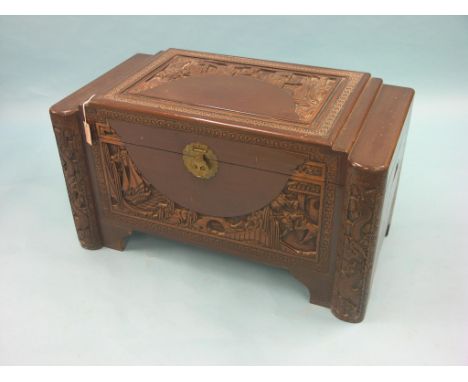 An Oriental camphorwood trunk, deeply-carved throughout, with engraved brass lock, 3ft. 4in. 