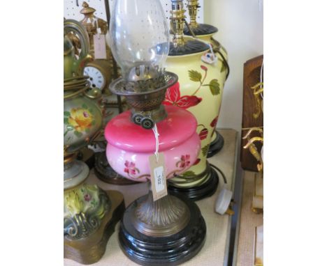 A Victorian oil lamp, with enamelled glass reservoir, pair of floral baluster table lamps, an adjustable brass table lamp and