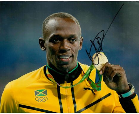 Sport Usain Bolt signed 10 x 8 colour portrait photo with his gold Medal and yellow track suit. . Good condition. All autogra