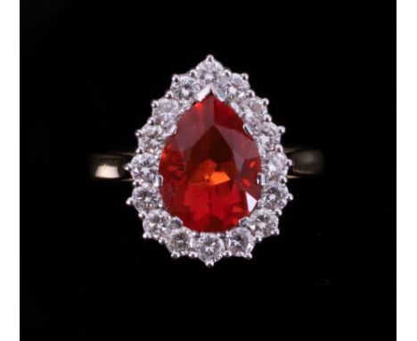 An 18ct yellow &amp; white gold pear shaped cluster ring set with a central pear shaped fire opal, approx. 2.75 carats, surro