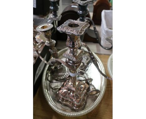 Pair of silver plated twin branch candlesticks, another single candlestick and an oval silver plated tray 