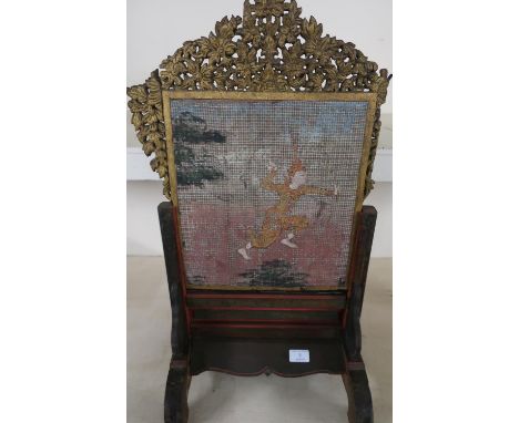 Burmese table screen, lift out panel, carved fretwork border and gilt detail, woven panel depicting figure in hardwood frame 